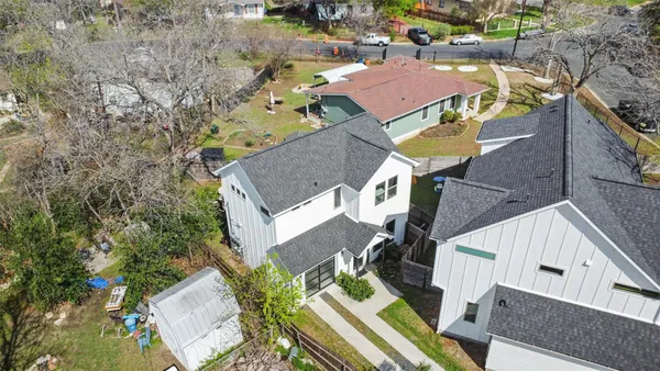 an aerial view of residential houses with outdoor space