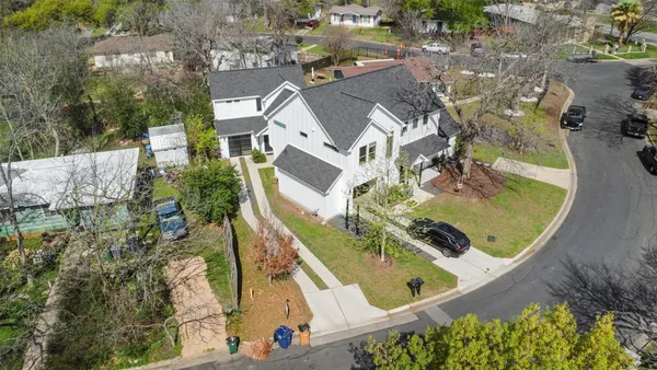 an aerial view of a house with a swimming pool