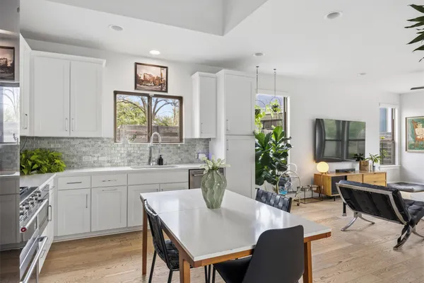 a kitchen with a table chairs refrigerator and cabinets