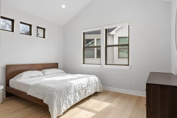 a bedroom with a bed and a window