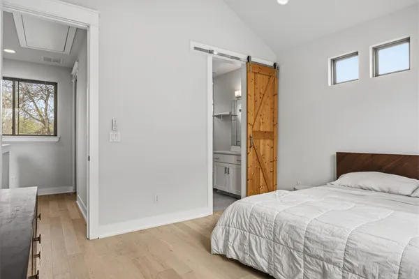 a bedroom with a bed and a mirror