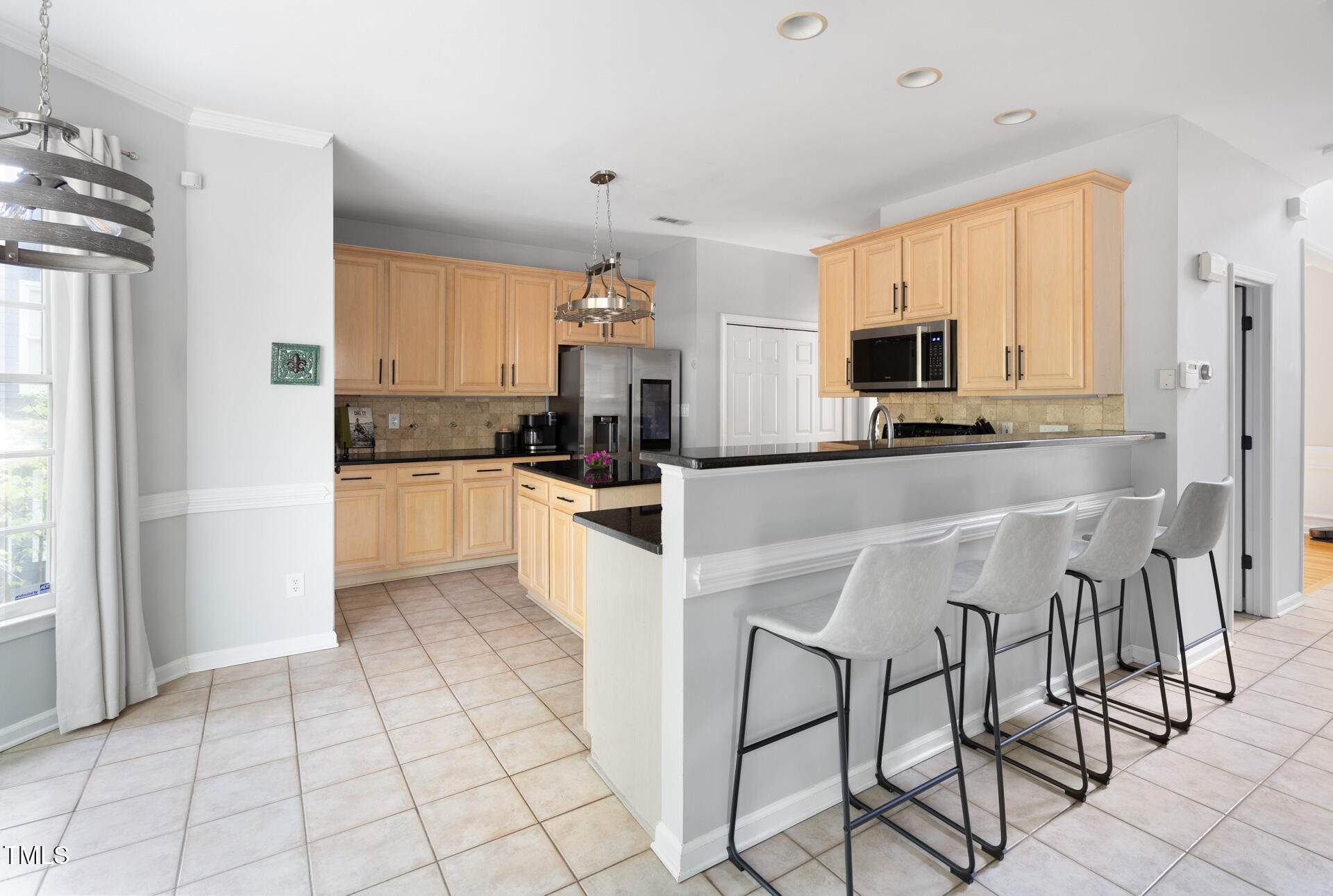 7 Wythebrook Lane Durham, NC 27713 - Photo 14 of 34 a kitchen with stainless steel appliances a refrigerator sink and cabinets