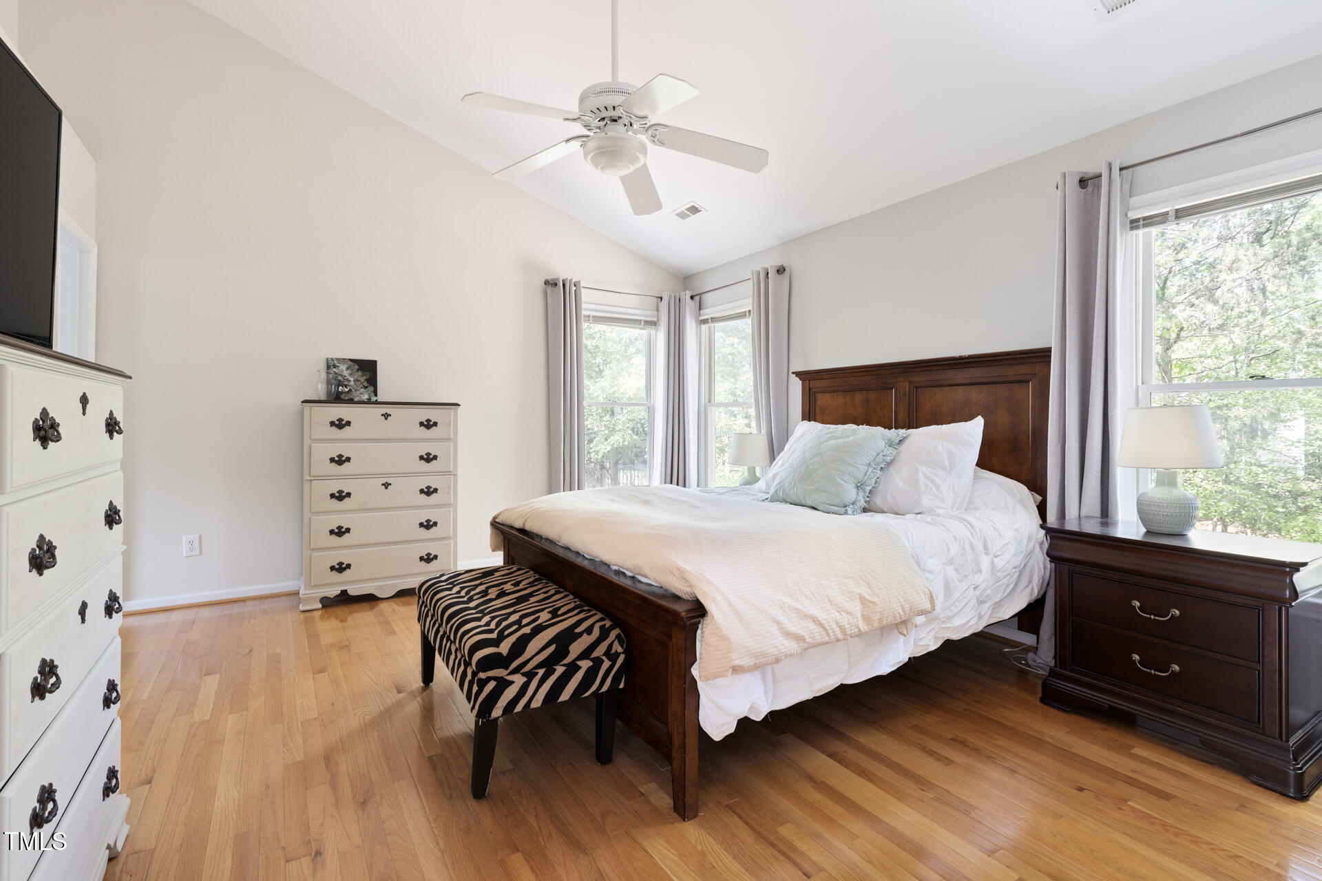 7 Wythebrook Lane Durham, NC 27713 - Photo 19 of 34 a bedroom with a bed and a dresser with wooden floor