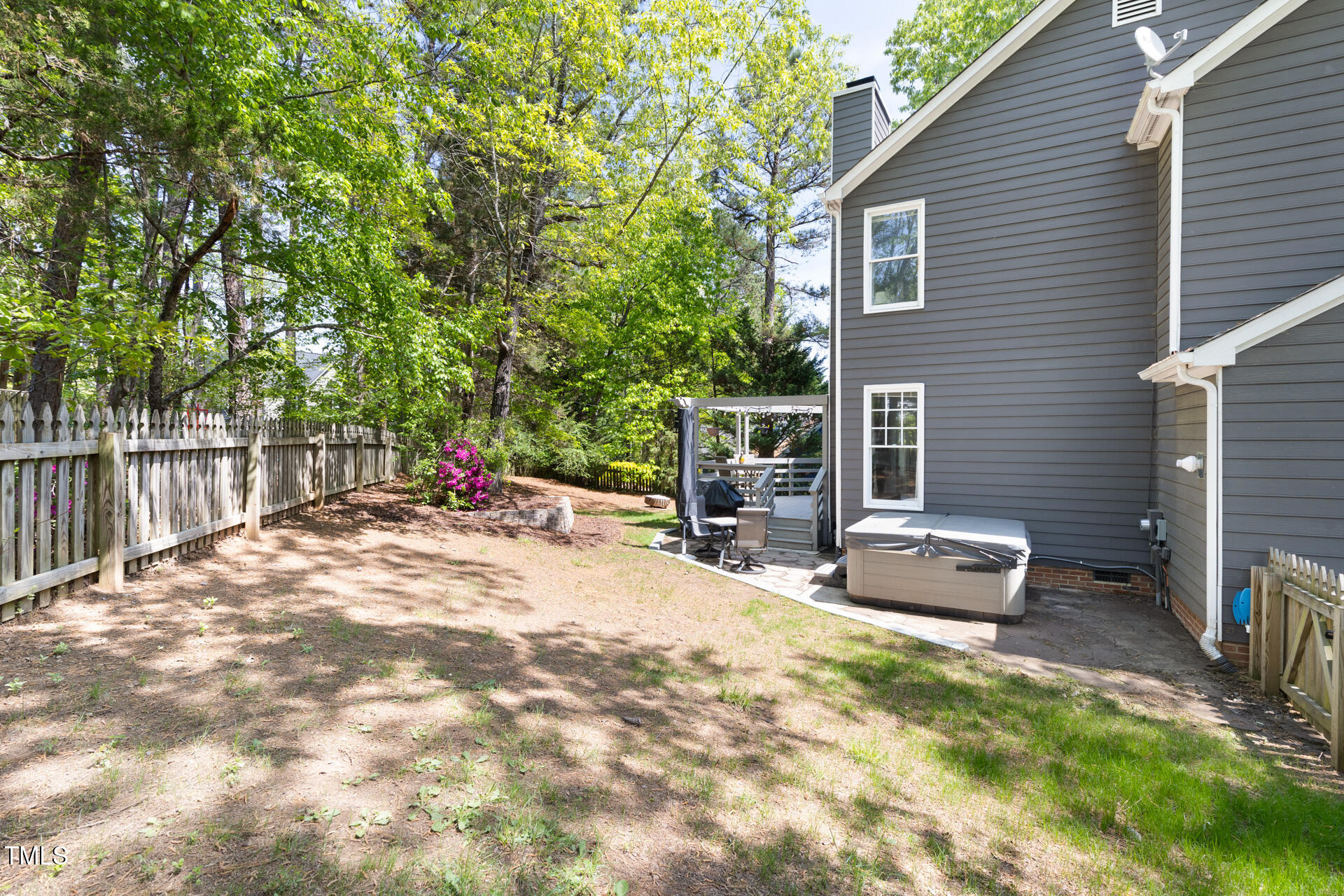 7 Wythebrook Lane Durham, NC 27713 - Photo 32 of 34 a backyard of a house with table and chairs a barbeque with wooden fence