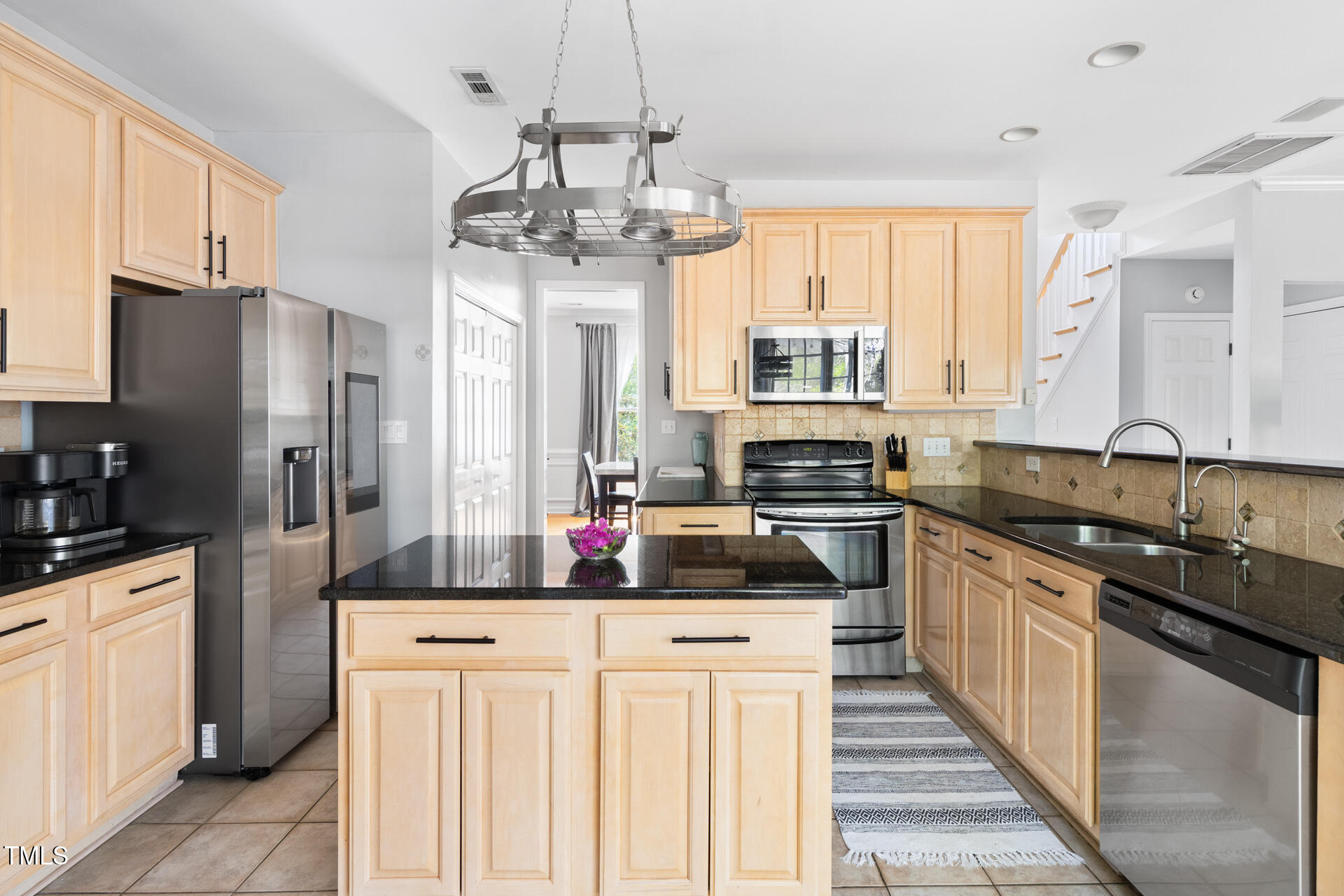 7 Wythebrook Lane Durham, NC 27713 - Photo 9 of 34 a kitchen with stainless steel appliances a sink stove and refrigerator