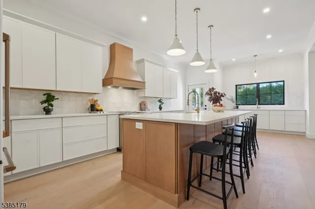 a kitchen with a table chairs microwave and cabinets