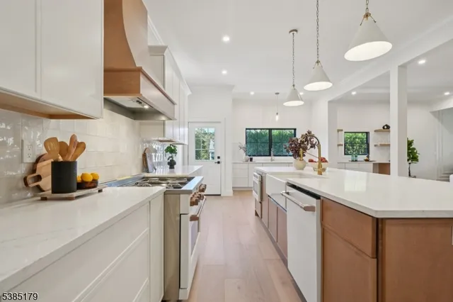 a kitchen with kitchen island a sink appliances and cabinets