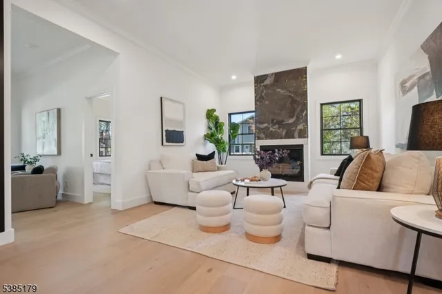 a living room with fireplace furniture and a wooden floor