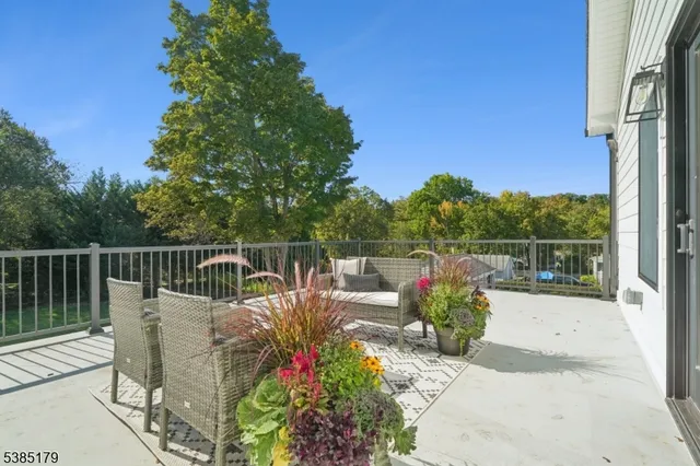 a view of a chairs and table in the balcony