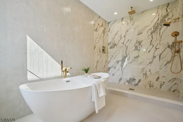 a bathroom with a bathtub and shower