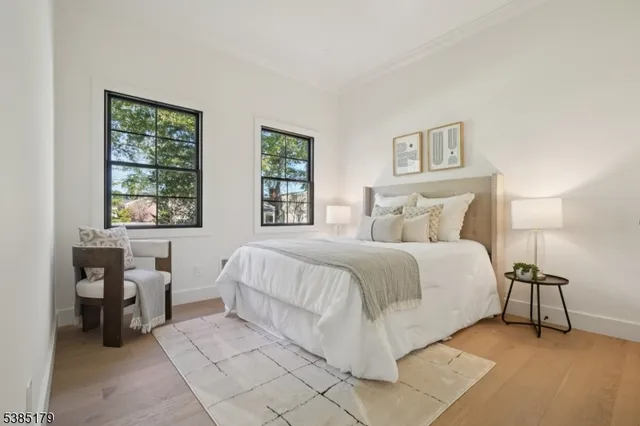 a bedroom with a bed lamps and window