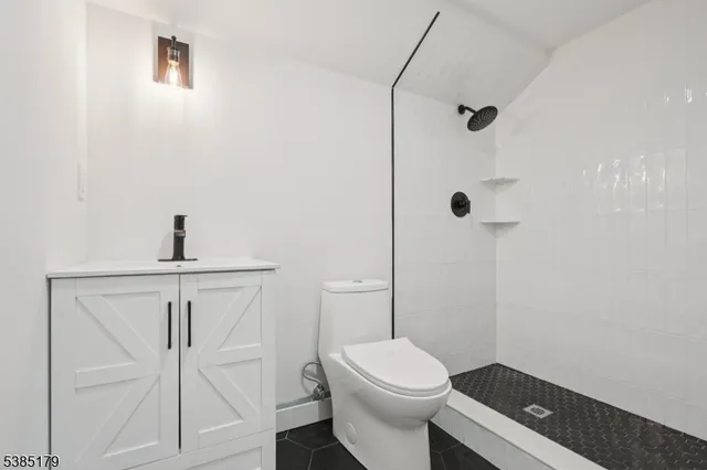 a bathroom with a toilet a sink and shower
