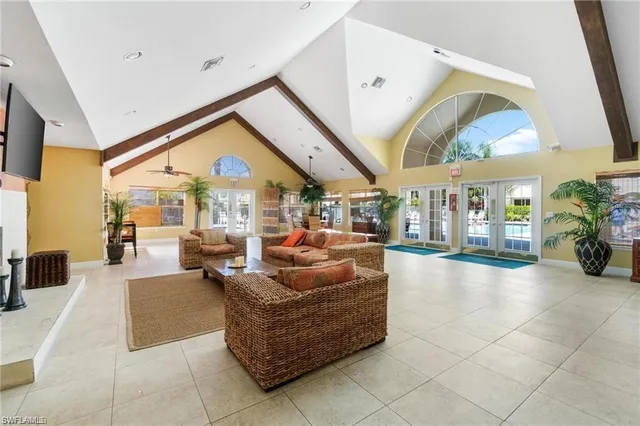 a living room with furniture a rug and a large window