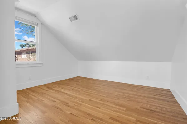a view of a livingroom with wooden floor and a flat screen tv