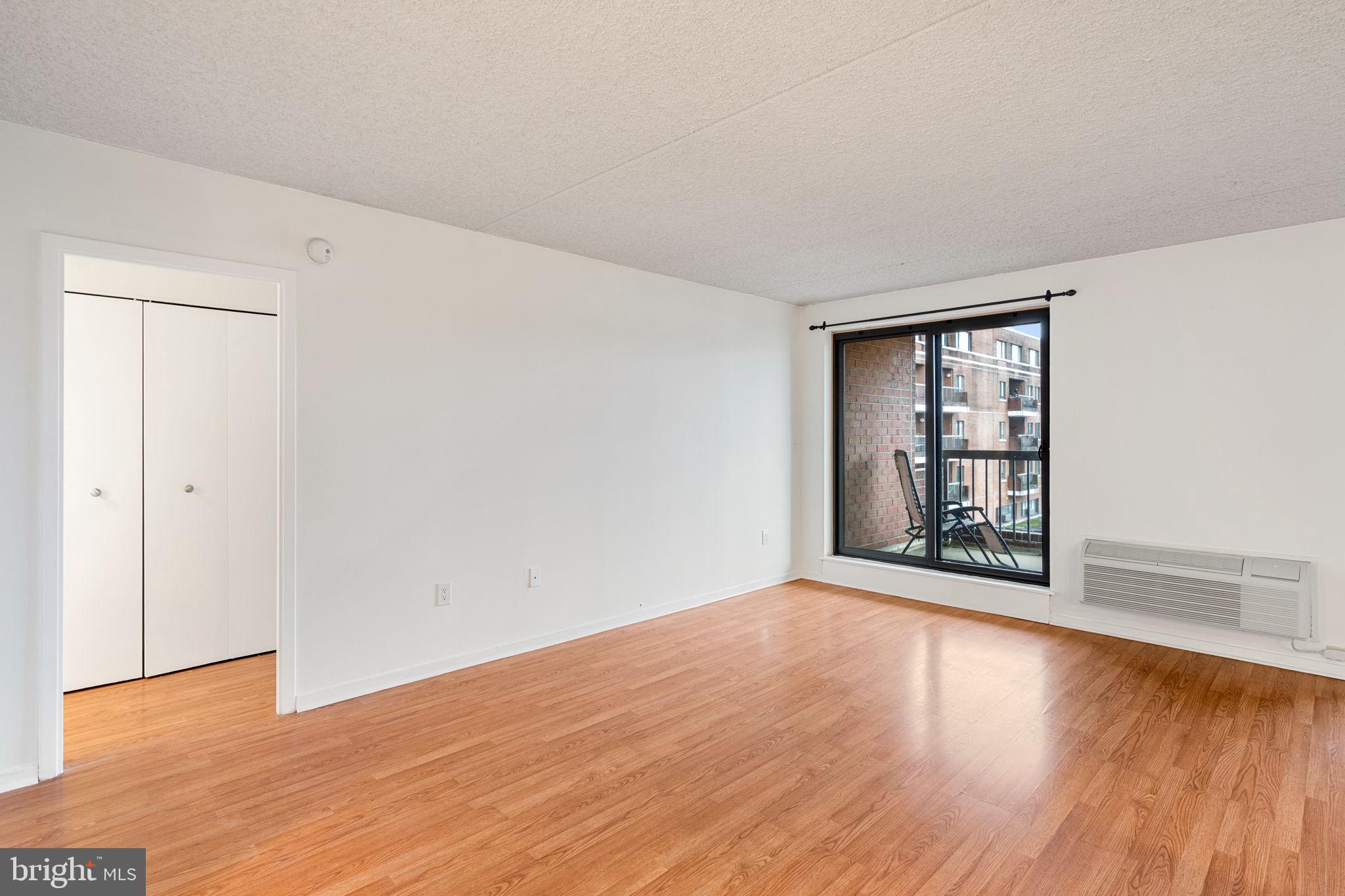200 Lombard Street, Unit 602 Philadelphia, PA 19147 - Photo 12 of 32 a view of an empty room with wooden floor and a window