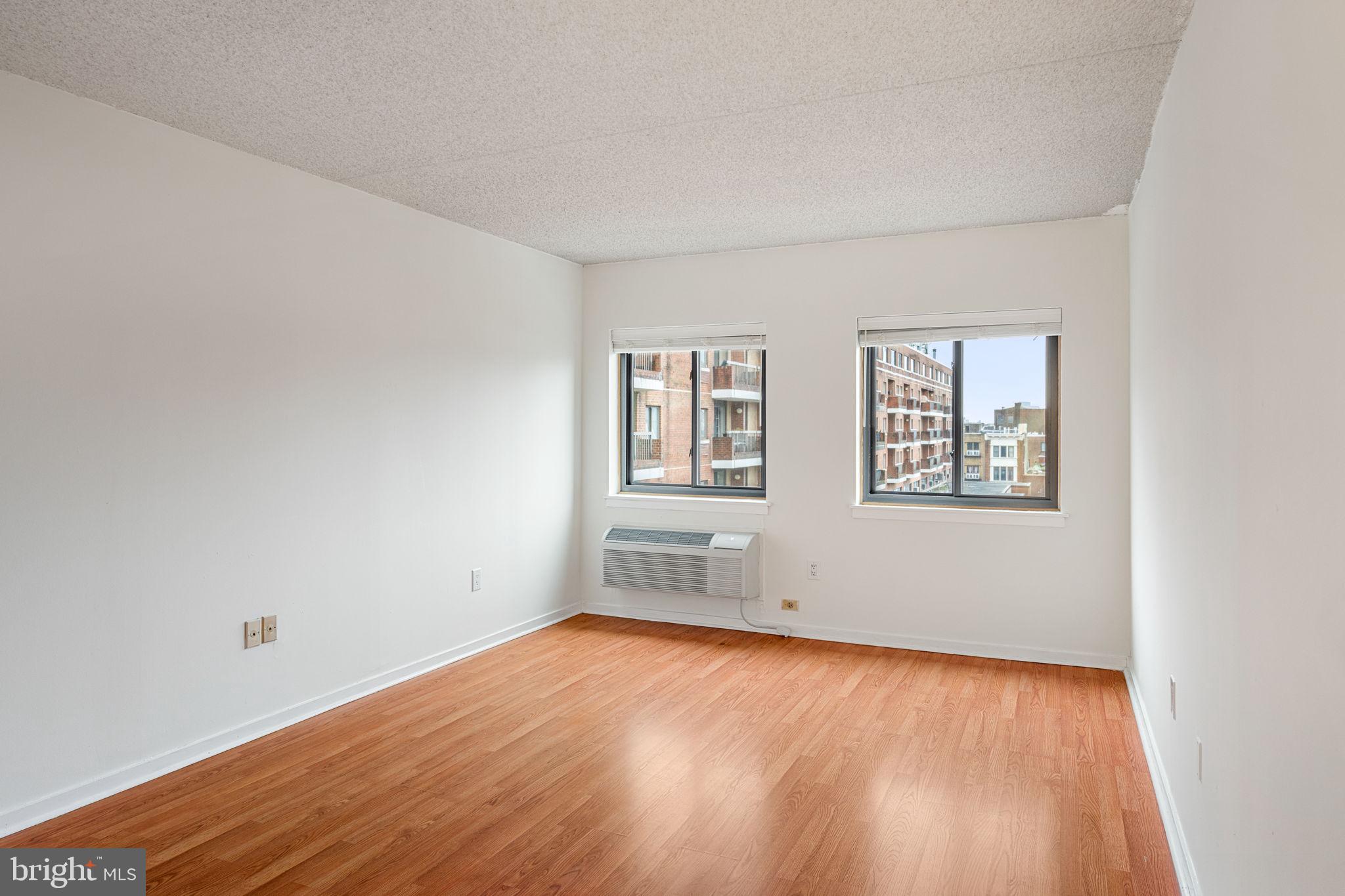 200 Lombard Street, Unit 602 Philadelphia, PA 19147 - Photo 17 of 32 an empty room with wooden floor and windows