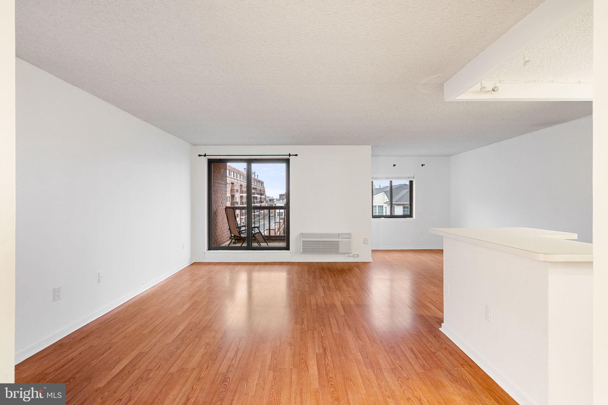200 Lombard Street, Unit 602 Philadelphia, PA 19147 - Photo 3 of 32 an empty room with wooden floor and windows
