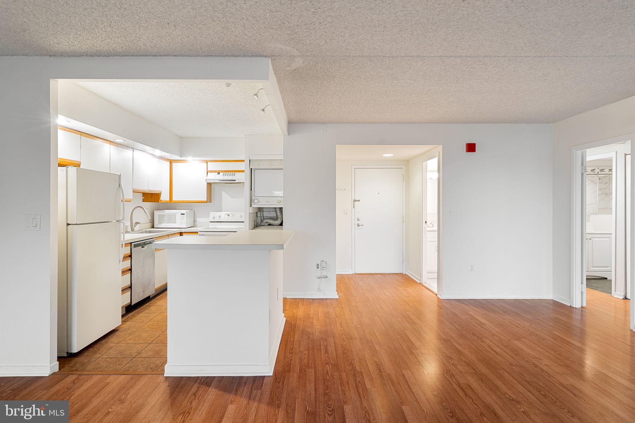 200 Lombard Street, Unit 602 Philadelphia, PA 19147 - Photo 8 of 32 a kitchen with a refrigerator sink and cabinets