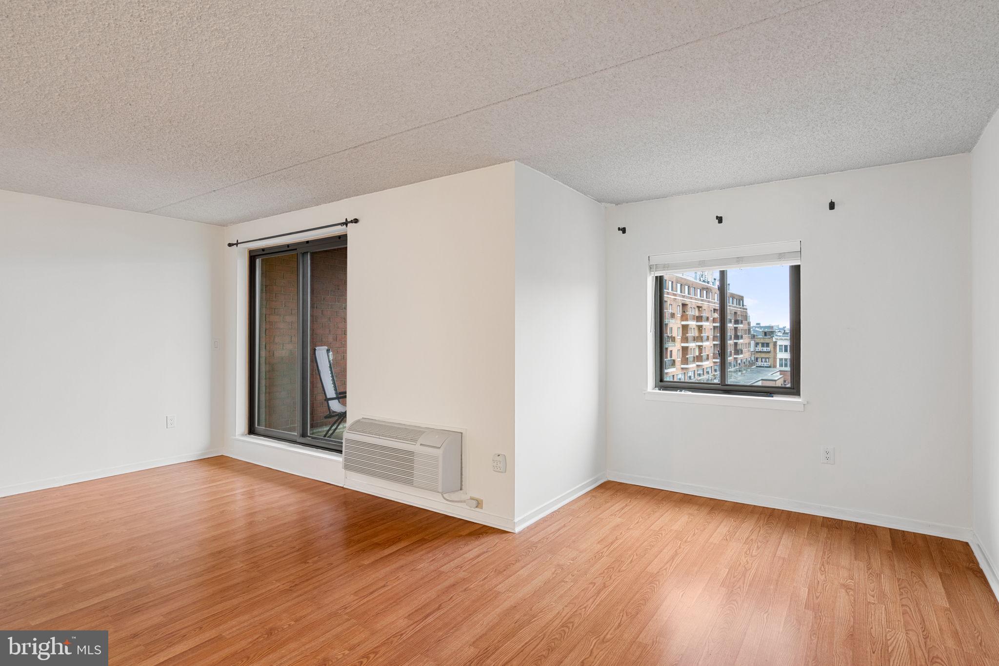 200 Lombard Street, Unit 602 Philadelphia, PA 19147 - Photo 10 of 32 a view of an empty room with wooden floor and a window