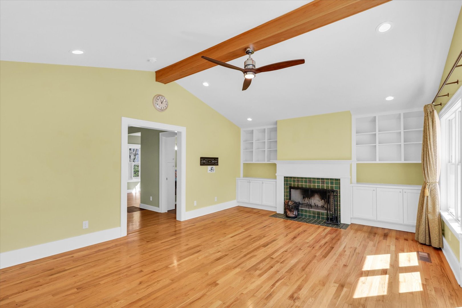 911 West Daniel Street Champaign, IL 61821 - Photo 13 of 44 a view of empty room with a fireplace and wooden floor