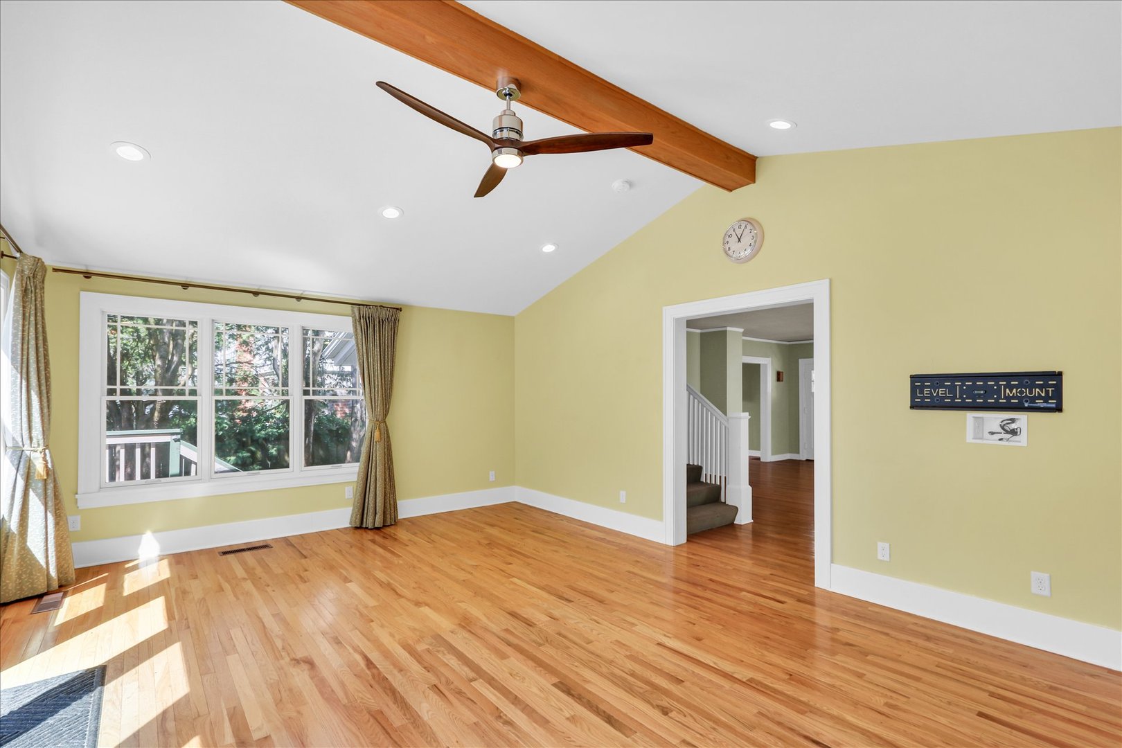 911 West Daniel Street Champaign, IL 61821 - Photo 14 of 44 a view of empty room with wooden floor and fan