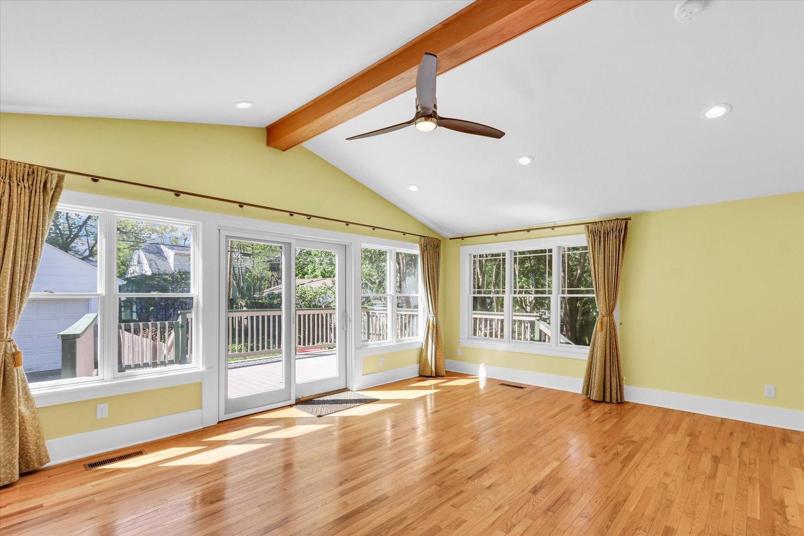 911 West Daniel Street Champaign, IL 61821 - Photo 15 of 44 a view of an empty room with wooden floor and a window