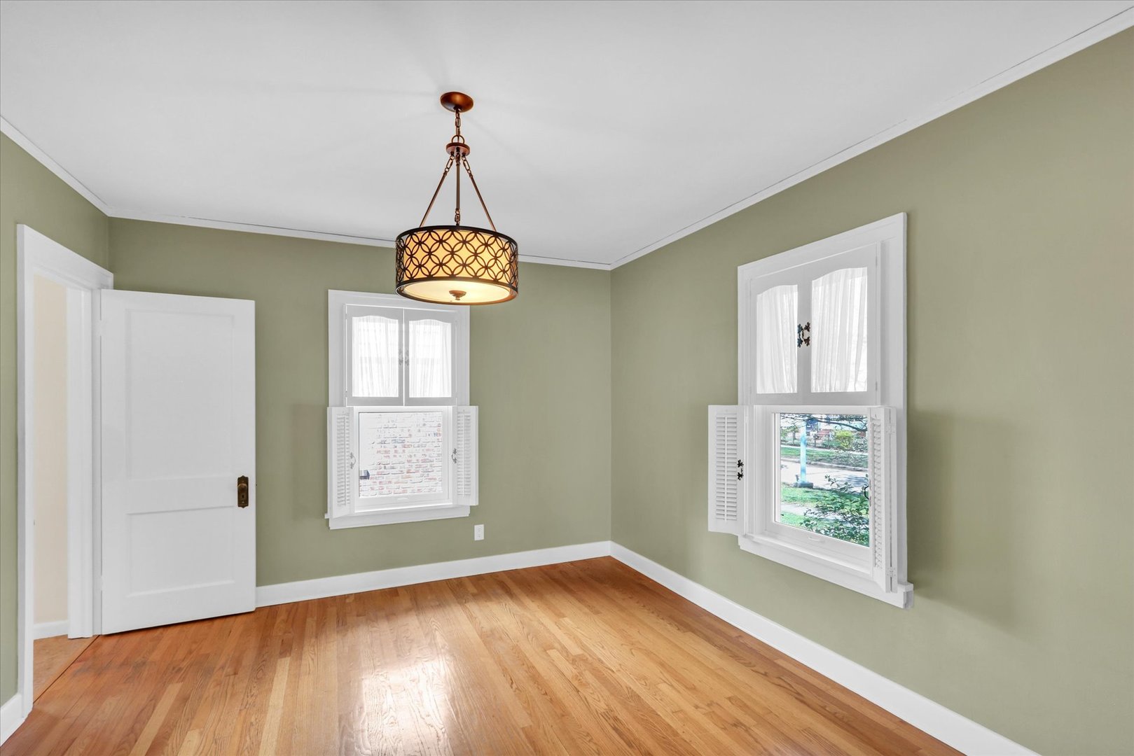 911 West Daniel Street Champaign, IL 61821 - Photo 17 of 44 a view of an empty room with wooden floor and a window