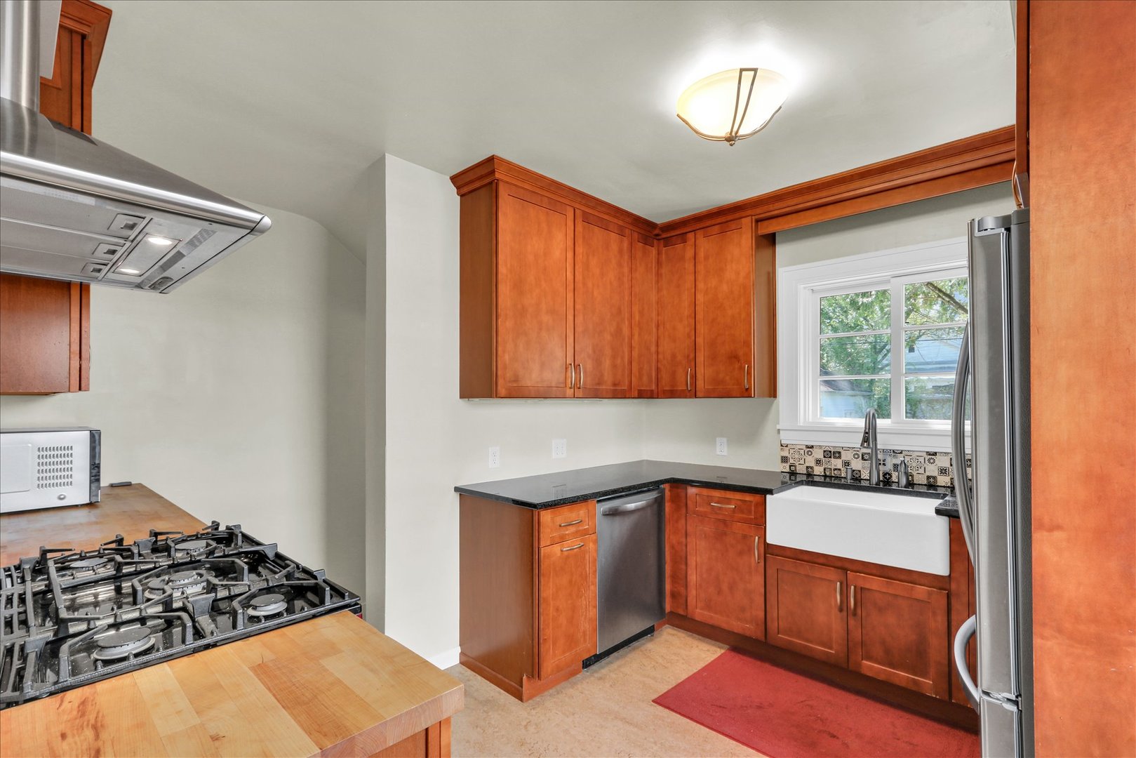 911 West Daniel Street Champaign, IL 61821 - Photo 19 of 44 a kitchen with a stove a sink and a refrigerator