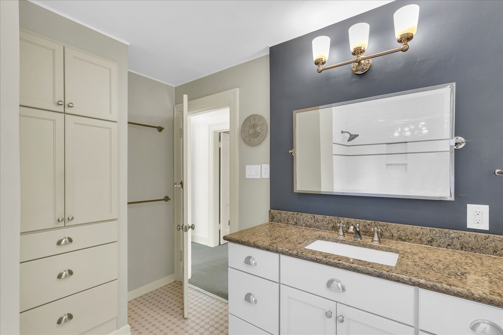 911 West Daniel Street Champaign, IL 61821 - Photo 32 of 44 a bathroom with a granite countertop sink and a mirror