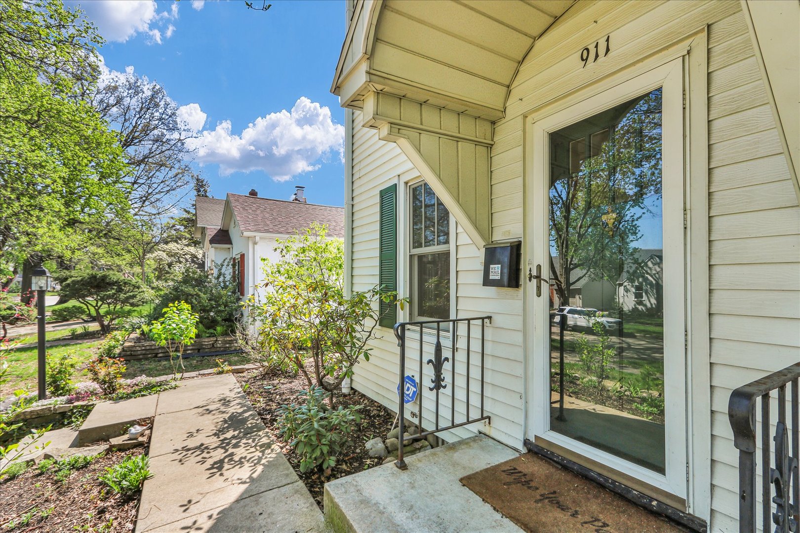 911 West Daniel Street Champaign, IL 61821 - Photo 5 of 44 a view of a porch with plants and floor to ceiling window