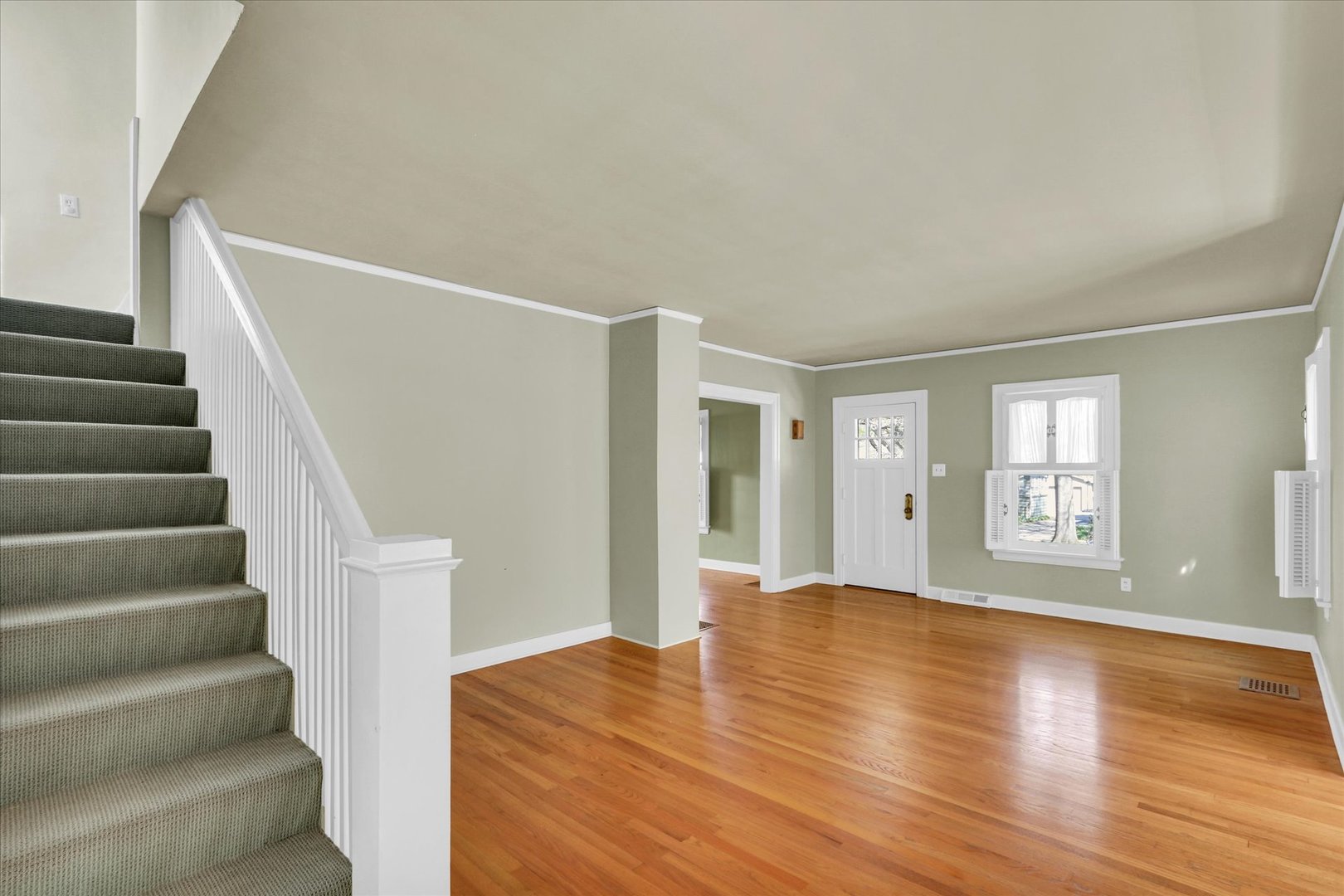 911 West Daniel Street Champaign, IL 61821 - Photo 8 of 44 a view of an empty room with wooden floor and windows