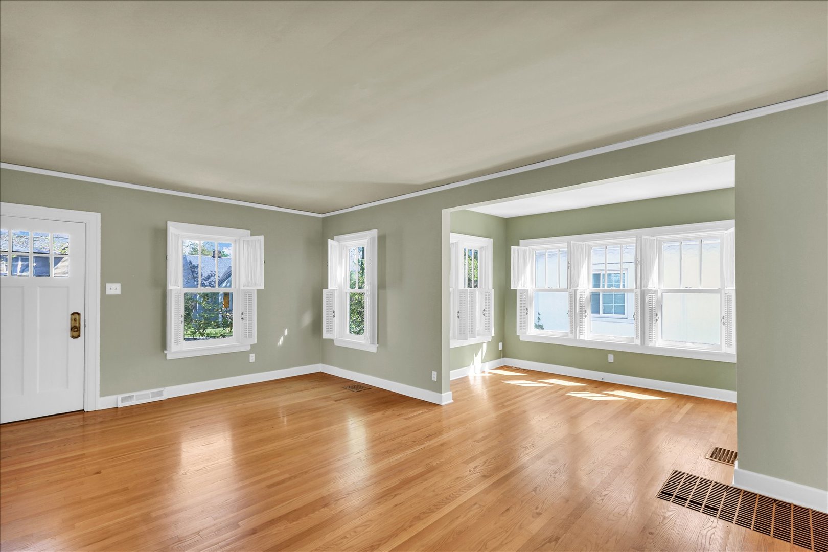 911 West Daniel Street Champaign, IL 61821 - Photo 9 of 44 a view of an empty room with wooden floor and a window