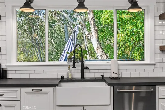 a white stove top oven sitting inside of a kitchen