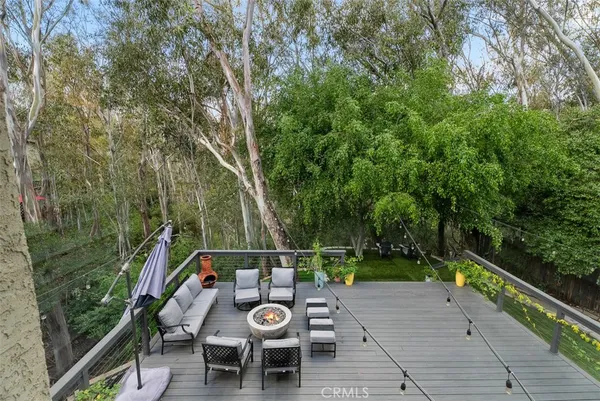 a view of a deck with two chair and wooden floor