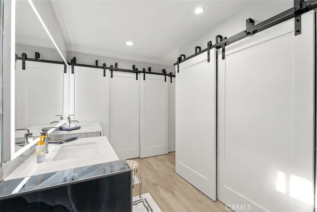 a bathroom with a sink mirror vanity and shower