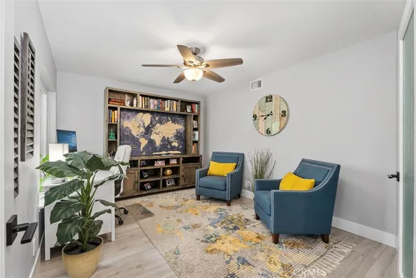 a living room with furniture a rug and a window