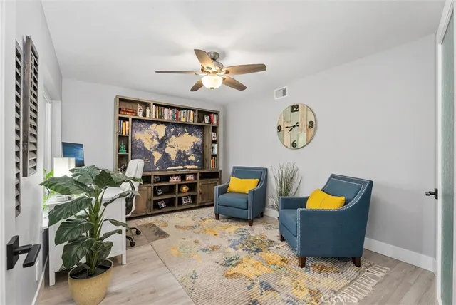 a living room with furniture a rug and a window