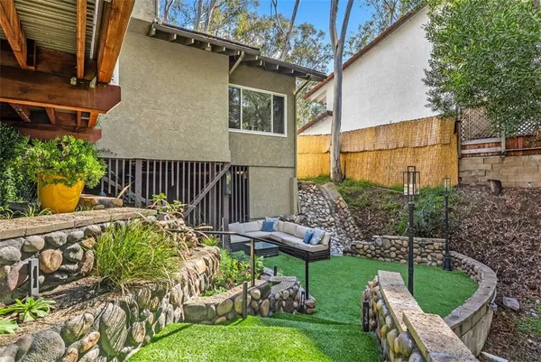 a view of a chair and table in the garden