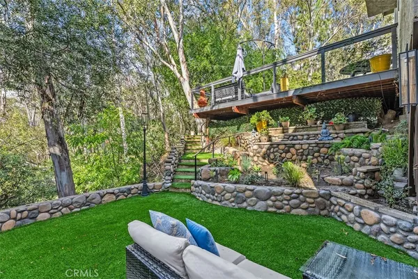 a view of a big yard with a small pool and a fountain