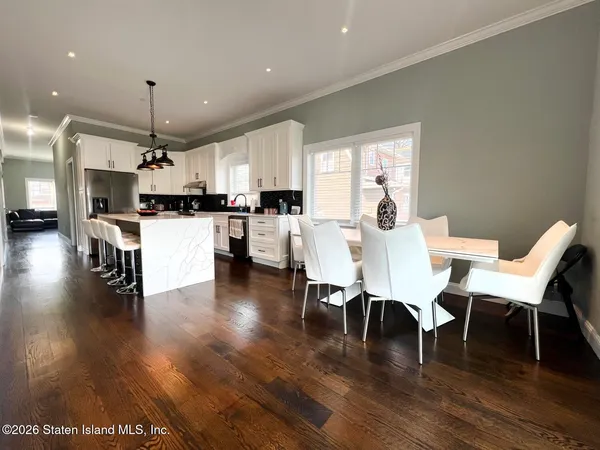 a dining room with furniture and wooden floor