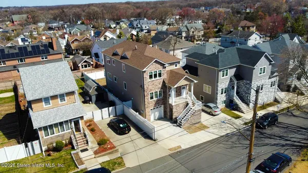 an aerial view of residential houses with outdoor space
