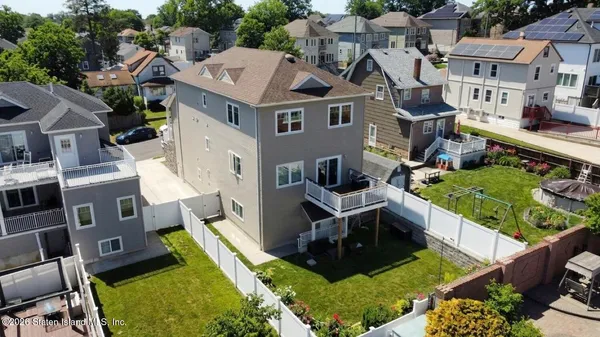 an aerial view of multiple houses with yard
