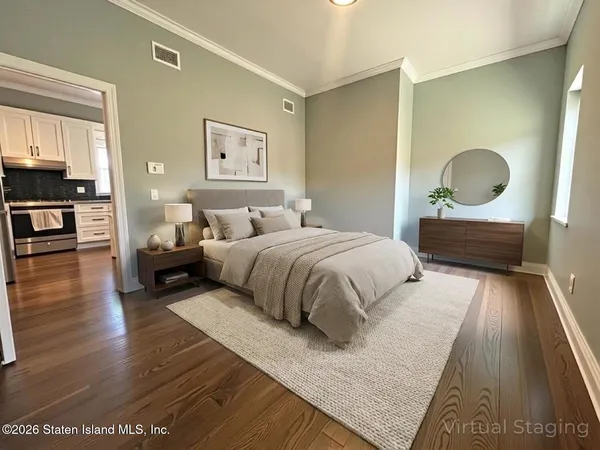 a view of entryway and gallery with wooden floor