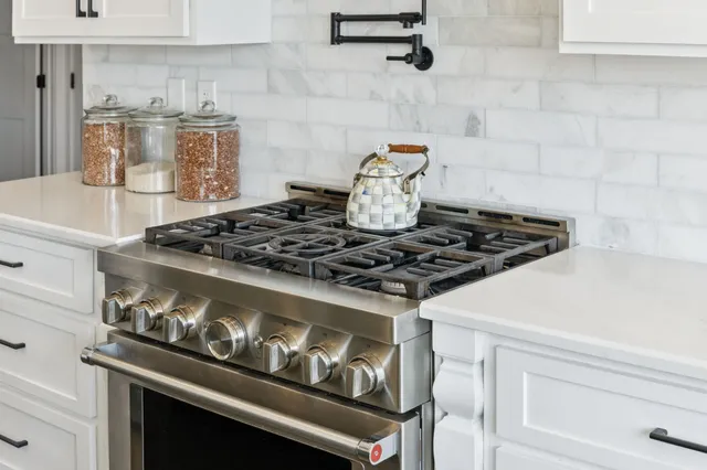 a spacious bedroom with a bed and a chandelier