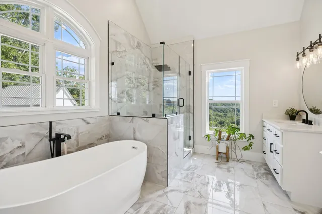 a view of staircase with lots of frames on wall and a window