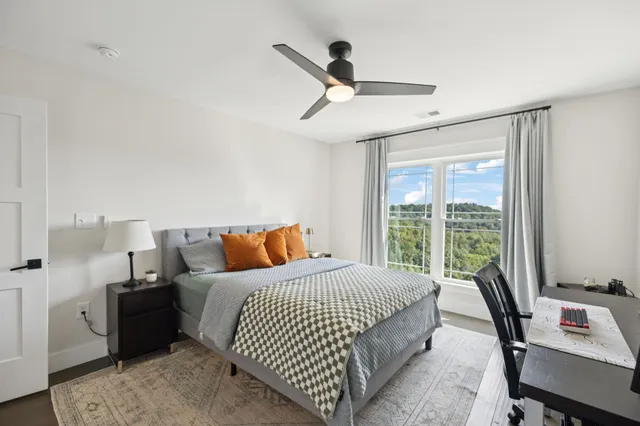 a kitchen with stainless steel appliances kitchen island granite countertop a sink and white cabinets