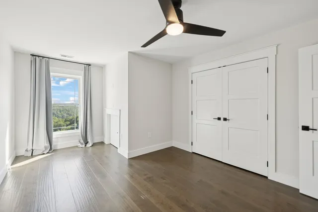 a view of a livingroom with wooden floor and a window