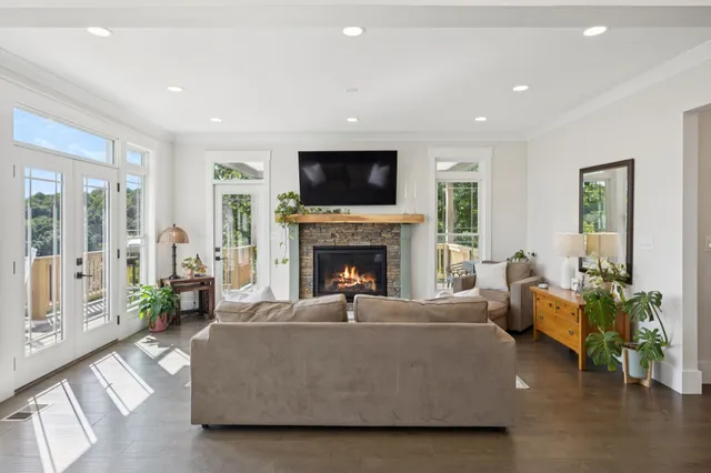 a kitchen with stainless steel appliances granite countertop a stove a sink and white cabinets