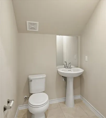 a bathroom with a sink a toilet and mirror