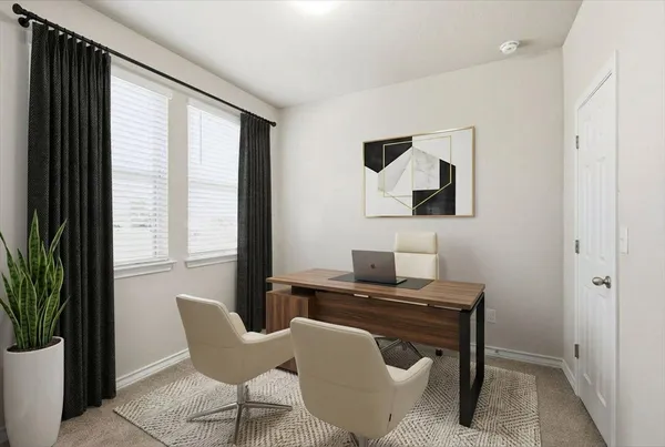 a view of a workspace with furniture and a window